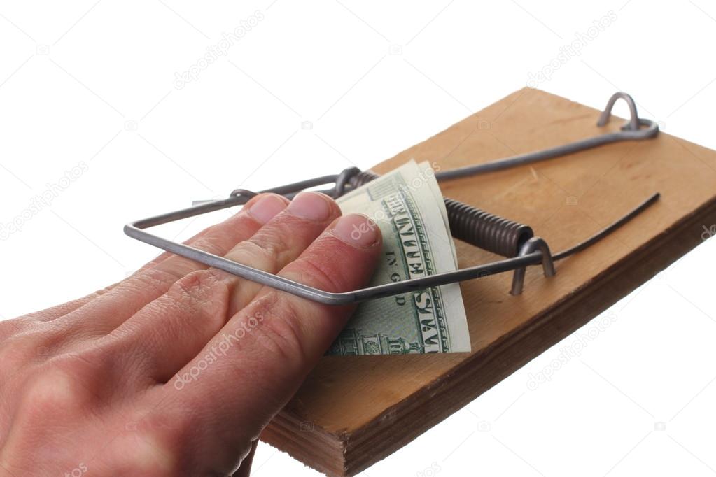 Trap with dollar bills isolated over white background, Risk in business, Businessman taking money from a mousetrap.