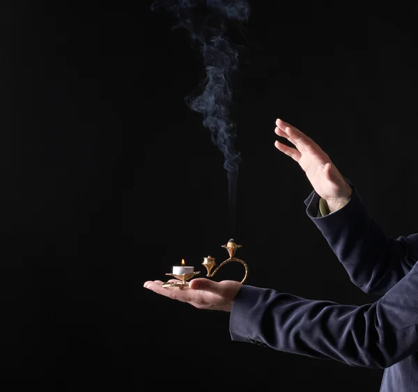 Candle smoke in hands — Stock Photo, Image
