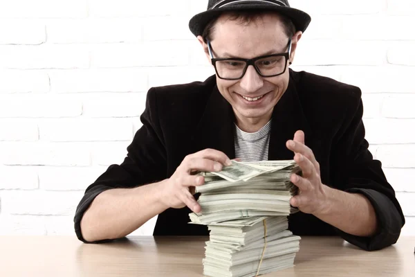 Emocionální muž v brýlích držení balíky peněz — Stock fotografie