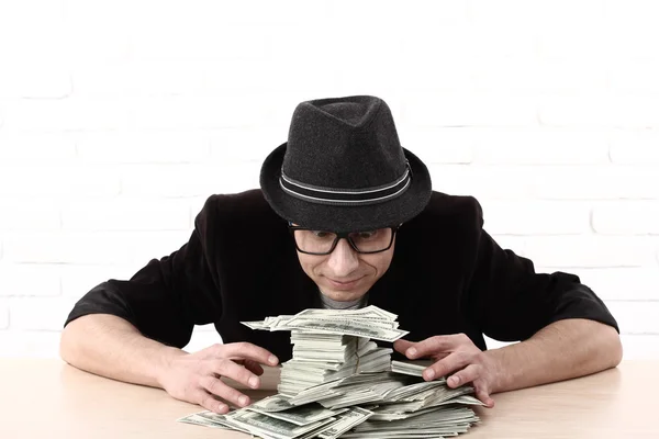 stock image Emotional man in glasses holding bundles of money