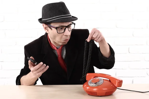 Disappointed handsome, angry, man showing old phone, do non know how to use it — Stock Photo, Image