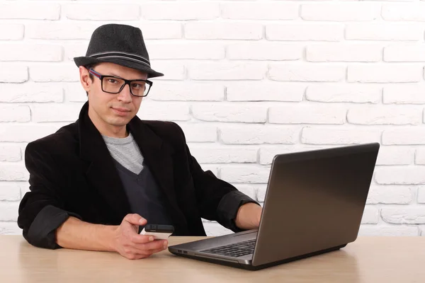 Happy man using smartphone and laptop computer. — Stock Photo, Image