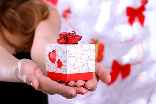 Hands holding beautiful gift box, female giving gift, Christmas holidays — Stock Photo, Image
