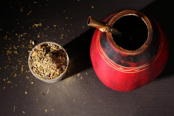 South American yerba mate tea dried leaves with a wooden mate cup