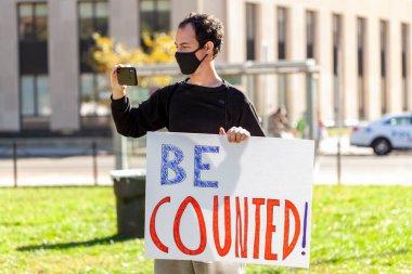 Washington DC, USA, 11/06/2020: After the elections, Anti-Trump Protesters make demonstrations near White House. A young man holds a banner that says be Counted referring to vote counting clipart