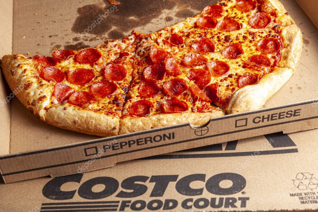 Clarksburg, MD, USA 04-07-2021: Close up isolated image of delicious fresh made pepperoni pizza sliced and placed in  cardboard box. It is a popular food court item at bargain price offered at COSTCO