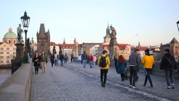 Prague, Czech Republic - 19.02.2021: Czech people on Charles bridge in winter 2021 without tourists, sunset time in Prague, Czech republic — Stock Video