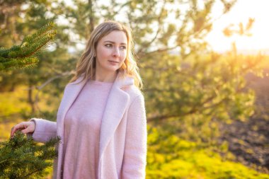 Young woman with a bouquet of tulips at the park, spring nature