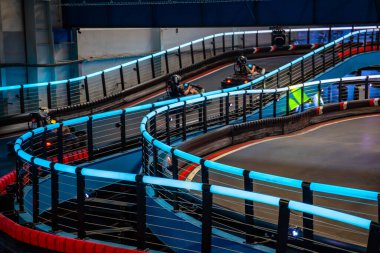 Prague, Czech Republic - September 21, 2025: Participants driving go-karts at CMKarting track. Recreational motorsport, adrenaline entertainment and modern leisure activities in an urban environment.