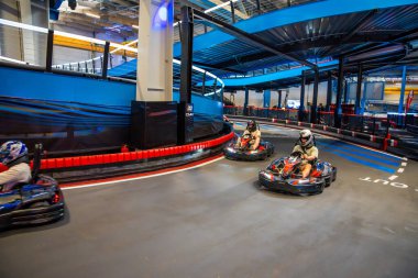 Prague, Czech Republic - September 21, 2025: Participants driving electric go-karts at CMKarting track. Sustainable motorsport, adrenaline entertainment and modern electric mobility. 