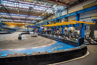 Prague, Czech Republic - September 21, 2025: Participants driving go-karts at CMKarting track. Recreational motorsport, adrenaline entertainment and modern leisure activities in an urban environment.