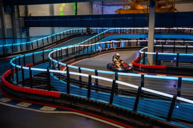 Prague, Czech Republic - September 21, 2025: Participants driving go-karts at CMKarting track. Recreational motorsport, adrenaline entertainment and modern leisure activities in an urban environment.