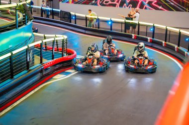 Prague, Czech Republic - September 21, 2025: Participants driving go-karts at CMKarting track. Recreational motorsport, adrenaline entertainment and modern leisure activities in an urban environment.