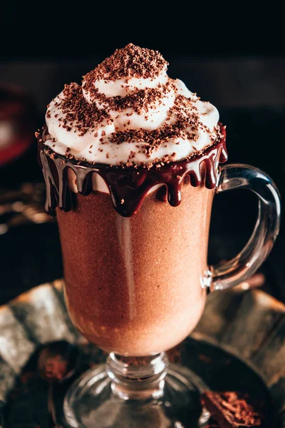 Milkshake with chocolate and whipped cream, dark photo. High quality photo