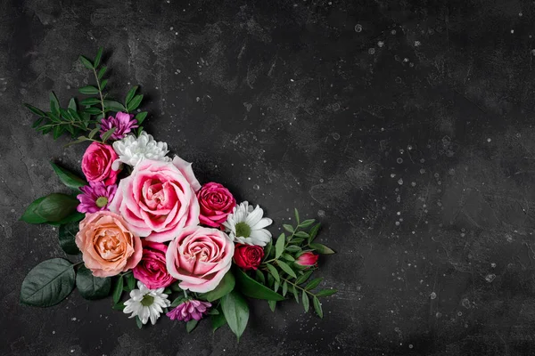 Composition of delicate summer flowers on a black background top view, free space for text. Bouquet of pink roses and white daisies — Stock Photo, Image