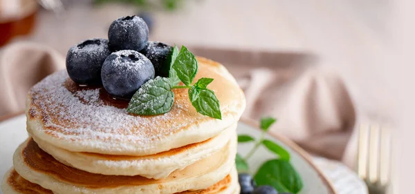 Web banner with homemade pancakes with blueberries and powdered sugar on the table close-up — Stock Photo, Image