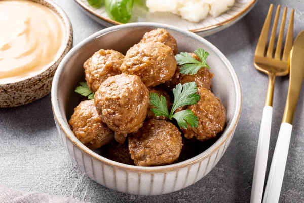 Traditional swedish meatballs with creamy sauce and mashed potatoes on gray table close up — Stock Photo, Image