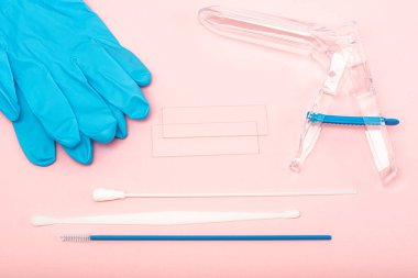 Disposable gynecological examination kit on a pink background. Gynecological examination set. The view from the top. Gynecological clinic. clipart