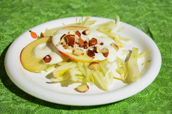 Italian food for Mediterranean healthy diet: salad with apple, fennel, lettuce and almonds