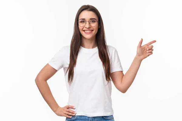 Waist-up portrait of confident smiling, friendly-looking young professional IT programmer female in glasses, inviting people join her company start career after graduation, point right — Stock Photo, Image