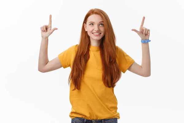 Portrait of happy young woman standing isolated over white wall background. Looking camera showing copyspace pointing — Stock Photo, Image
