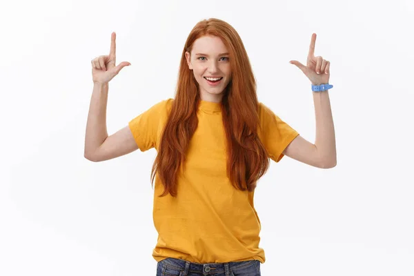 Portrait of happy young woman standing isolated over white wall background. Looking camera showing copyspace pointing — Stock Photo, Image