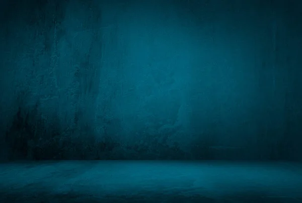 Vintage grunge blue concrete texture studio wall background with vignette.