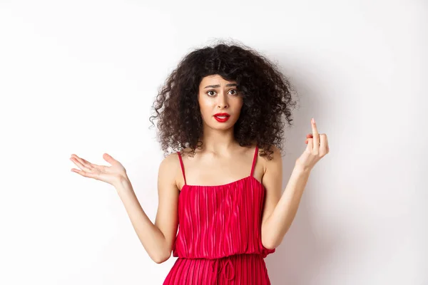 Annoyed caucasian woman in red dress, showing finger without wedding ring, arguing about marriage, standing pissed-off on white background — Stockfoto