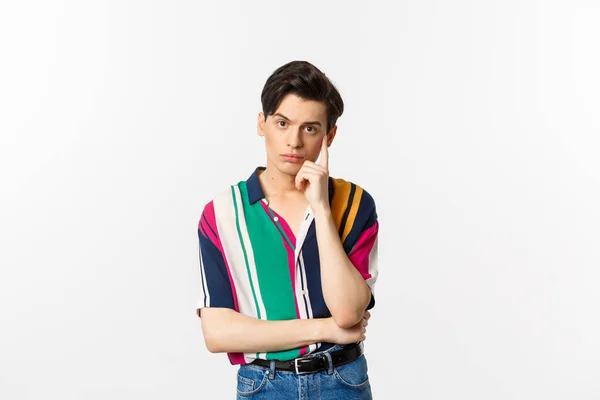 Image of attractive young man staring at camera with reluctant and annoyed emotion, standing over white background — Stock Photo, Image