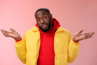 Indoor shot black bearded 25s guy shrugging hands raised sideways dismay clueless gesture have no idea standing careless questioned unaware what happened unbothered pink background clipart