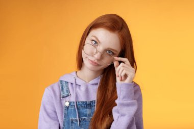 You gotta be kidding me. Annoyed redhead smart irritated elder sister look from under forehead take off glasses roll eyelids smirking disturbed pissed stupid jokes, standing orange background clipart