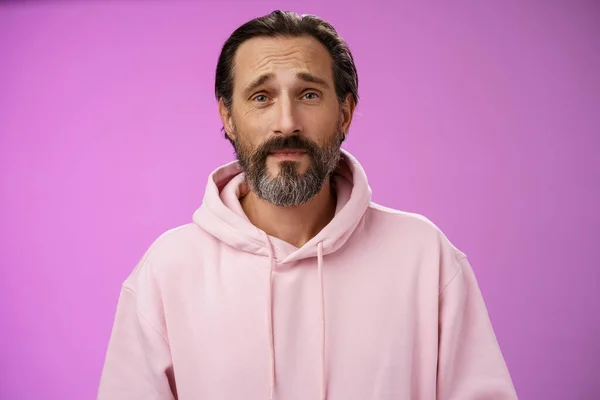 Upset worried unconfident adult bearded caucasian man grey hair frowning look hopefully nervously waiting important news, standing anxious hesitant unhappy, standing purple background unwell — Stock Photo, Image