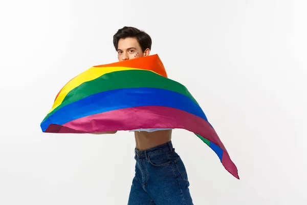 Mänskliga rättigheter och lgbtq community koncept. Ung queer person med glitter i ansiktet, viftande lgbtq flagga med stolthet, stående över vit bakgrund — Stockfoto