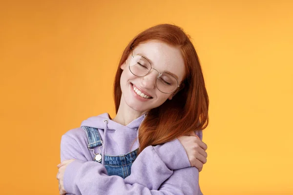 Close-up romantic lovely charming redhead girl enjoy warmth love tilting head close eyes dreamy imaging perfect date hugging herself embracing own body accept body-positivity orange background — Stock Photo, Image