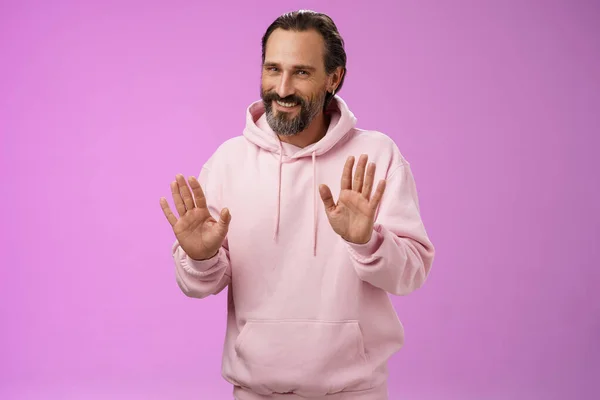 No thanks pass. Charming polite manly adult bearded man grey hair in pink hoodie apologizing refusal raise palms rejection gesture declining offer smiling say sorry not interested, purple background — Stock Photo, Image