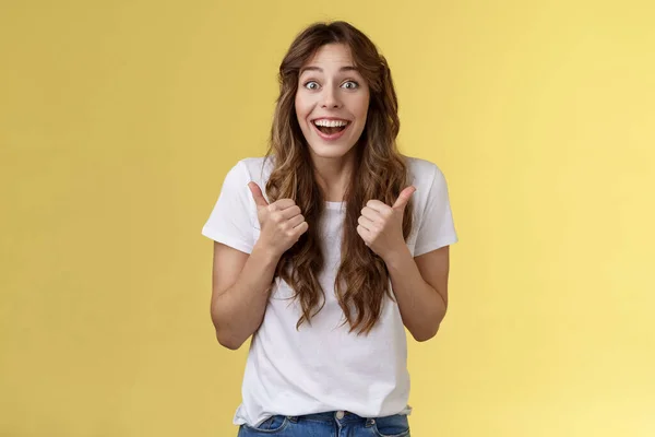 Animado animado feliz bonito europeu menina apoiante dar resposta positiva acho que o evento incrível sorrindo amplamente mostrar aprovação polegares-up, aceitar grande escolha stand fundo amarelo emocionado — Fotografia de Stock