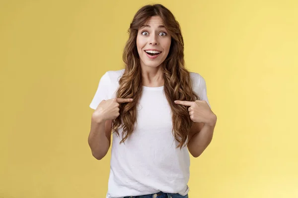 Surprised relieved pleased cute curly-haired girl receive promotion pointing herself lucky smile look camera astonished happily react awesome surprise indicating hopeful delighted yellow background — Stock Photo, Image