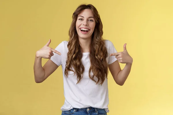 Haha awesome. Positive sincere attractive young woman curly long hair laughing joyfully pointing fingers center copy space white t-shirt chuckling having fun discuss great link show you promo — Stock Photo, Image