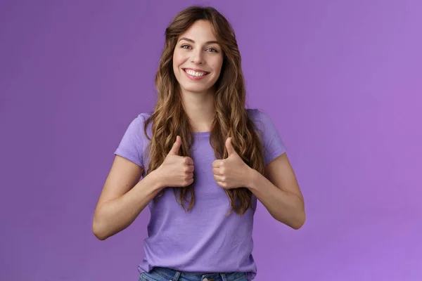 Upbeat positive attractive cheerful curly girl show thumbs up approval sign smiling delighted encourage friend good job well done standing satisfied like positive opinion purple background — Stock Photo, Image