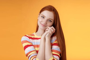 Dreamy sensual romantic young passionate redhead girlfriend melt heart feel sympathy joy receive sweet tender present lean palms smiling grateful gladly accept nice lovely gift, orange background clipart