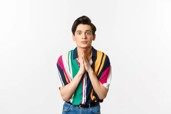 Image of hopeful young man begging for help, staring at camera and pleading for favour, asking advice, standing over white background — Stock Photo, Image