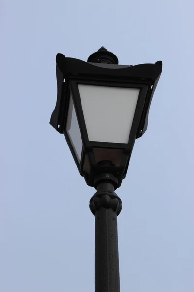 Poste lâmpada de rua preto contra o céu — Fotografia de Stock