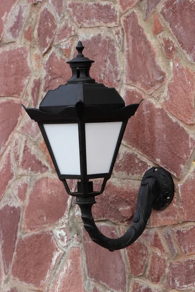 Street lamp on the background wall of stone — Stock Photo, Image