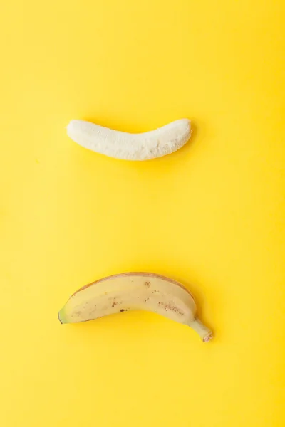 Peel banana and fruit on a yellow background — Stock Photo, Image