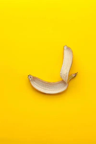 Peel banana on a yellow background — Stock Photo, Image