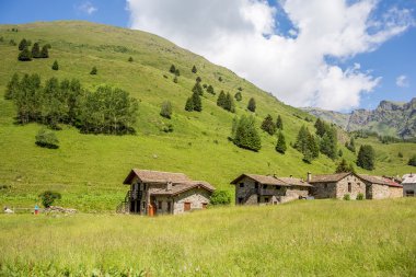 Stone chalets on a mountain view - Ponte di Legno, Italy clipart