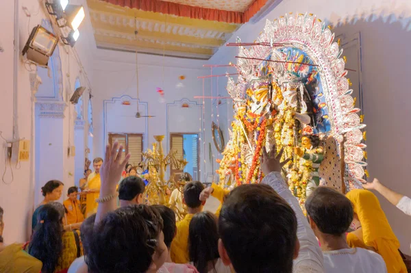 stock image Kolkata, West Bengal, India - 6th October 2019 : Flowers are thrown and Pushpanjali being offered by Hindu devotees to Goddess Durga at Shobhabazar Rajbari , bonedi barhir pujo. Durga Puja festival.