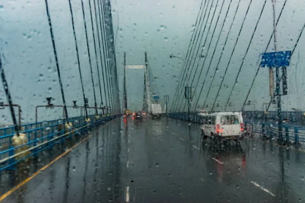 Batı Bengal, Kolkata 'daki 2. Hooghly Köprüsü olarak bilinen Ganj Nehri üzerindeki Vidyasagar Setu (Köprü). Soyut görüntü, her tarafında yağmur damlaları olan bir cam parçası, Kolkata 'nın muson resmi..