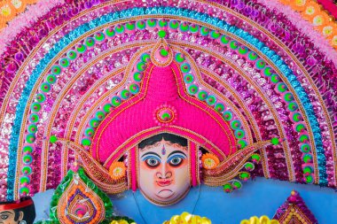 Purulia, West Bengal, India - August 15th 2017 : Colorful Chhau (or chhou) mask of Hindu God , handicrafts on display for sale. Chhau or Chhou is traditional tribal dance festival of India. clipart
