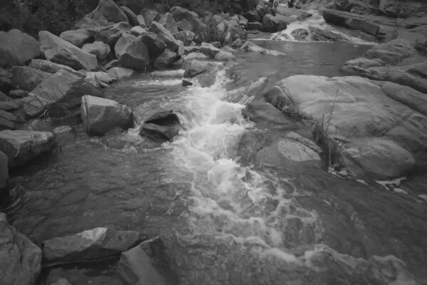Beautiful Ghatkhola waterfall having full streams of water flowing downhill amongst stones , duriing monsoon due to rain at Ayodhya pahar (hill) - at Purulia, West Bengal, India. Black & White image.